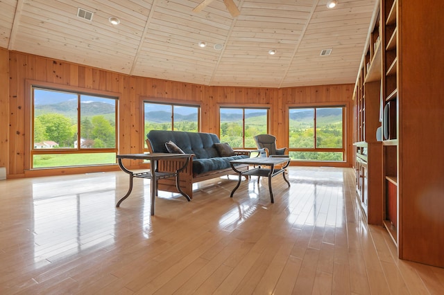 2222 Main Rd, Chatham, NH 03813 - living room with healthy amount of natural light, wooden walls, wooden ceiling, light wood finished floors, and high vaulted ceiling