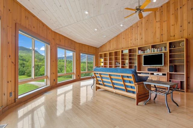 2222 Main Rd, Chatham, NH 03813 - living room with plenty of natural light, wood walls, wood ceiling, wood finished floors, and a ceiling fan