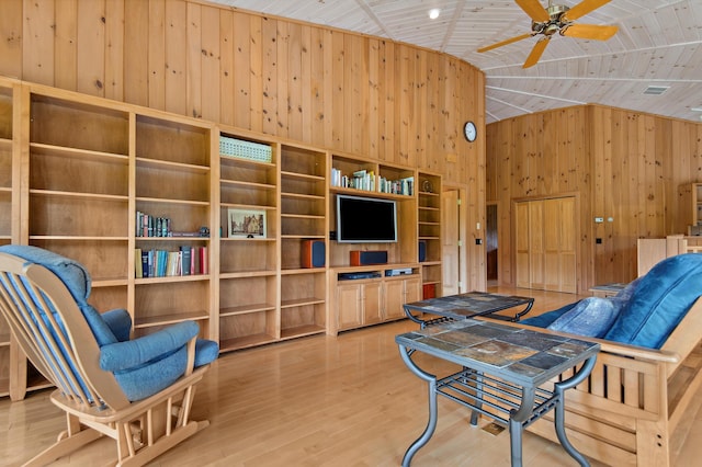 2222 Main Rd, Chatham, NH 03813 - living area with wood walls, a ceiling fan, wood ceiling, wood finished floors, and high vaulted ceiling