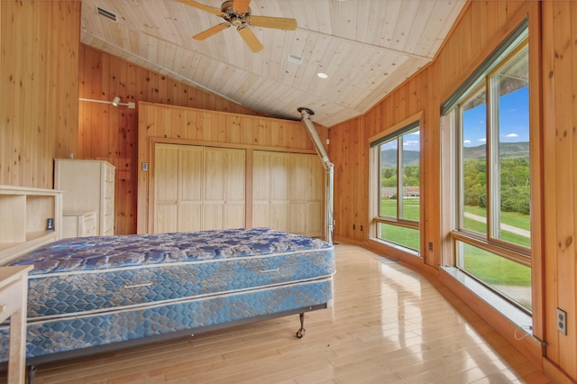 2222 Main Rd, Chatham, NH 03813 - bedroom with access to outside, wood walls, vaulted ceiling, wood ceiling, and hardwood / wood-style flooring