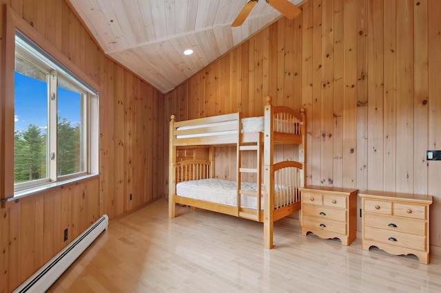2222 Main Rd, Chatham, NH 03813 - bedroom with baseboard heating, wooden walls, wood finished floors, lofted ceiling, and wooden ceiling