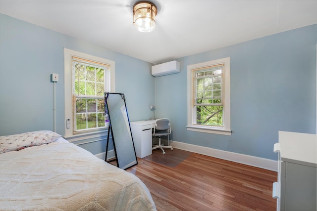 4 University Pl, Orono, ME 04473 - bedroom featuring a wall unit AC, multiple windows, wood finished floors, and baseboards