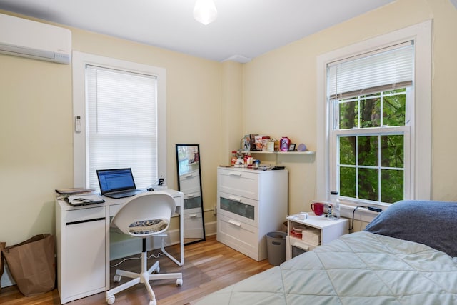 4 University Pl, Orono, ME 04473 - bedroom featuring a wall mounted air conditioner, light wood-type flooring, multiple windows, and an office area