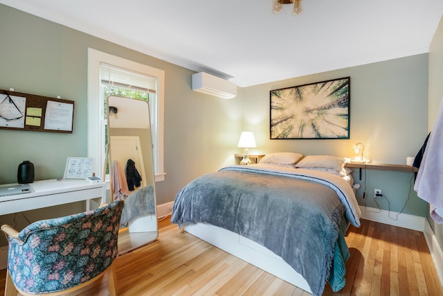 4 University Pl, Orono, ME 04473 - bedroom with a wall mounted air conditioner, wood-type flooring, crown molding, an office area, and baseboards
