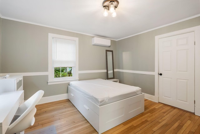 4 University Pl, Orono, ME 04473 - bedroom with an AC wall unit, light wood-style flooring, crown molding, and baseboards