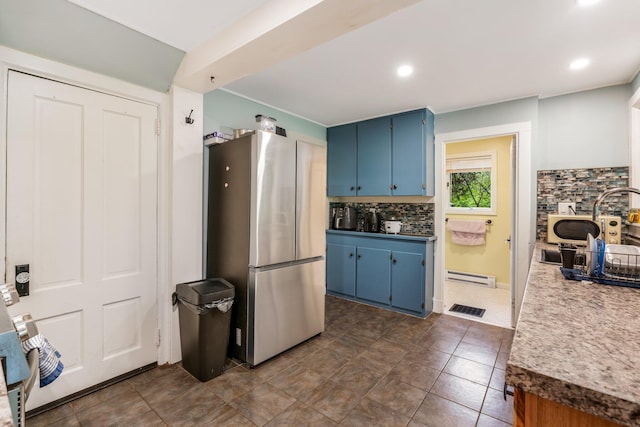 4 University Pl, Orono, ME 04473 - kitchen with freestanding refrigerator, blue cabinetry, decorative backsplash, a baseboard heating unit, and recessed lighting