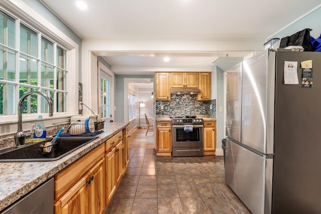 4 University Pl, Orono, ME 04473 - kitchen featuring appliances with stainless steel finishes, a sink, under cabinet range hood, decorative backsplash, and recessed lighting