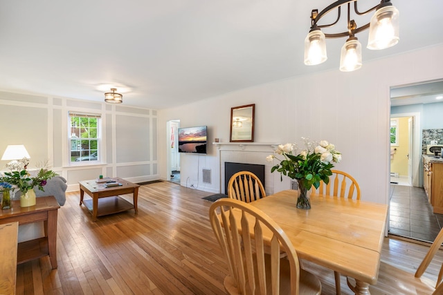 4 University Pl, Orono, ME 04473 - dining room featuring light wood-type flooring and a brick fireplace