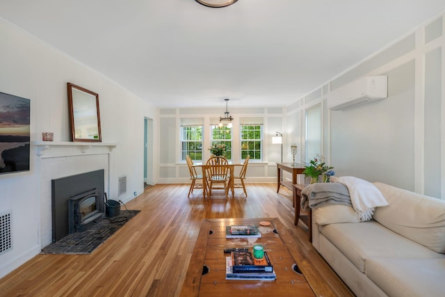 4 University Pl, Orono, ME 04473 - living room featuring a wall mounted AC, light wood-style floors, and baseboards