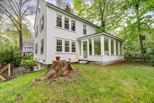 4 University Pl, Orono, ME 04473 - rear view of property featuring a chimney, a sunroom, a lawn, and entry steps
