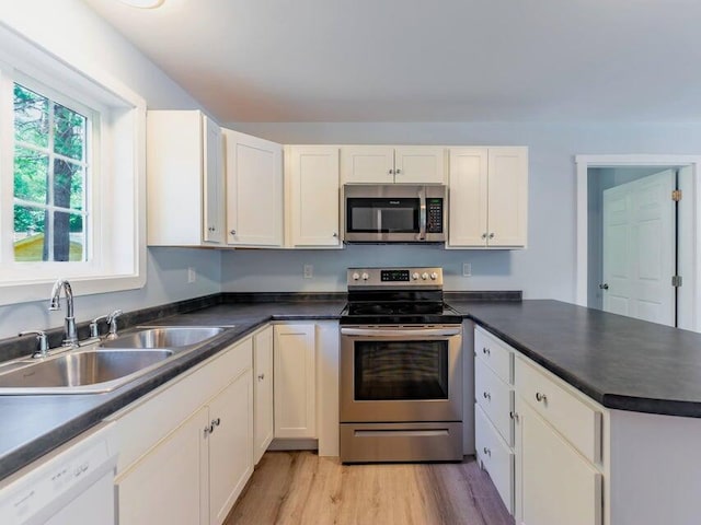 37 Bog Rd, Augusta, ME 04330 - kitchen with appliances with stainless steel finishes, a sink, a peninsula, and dark countertops