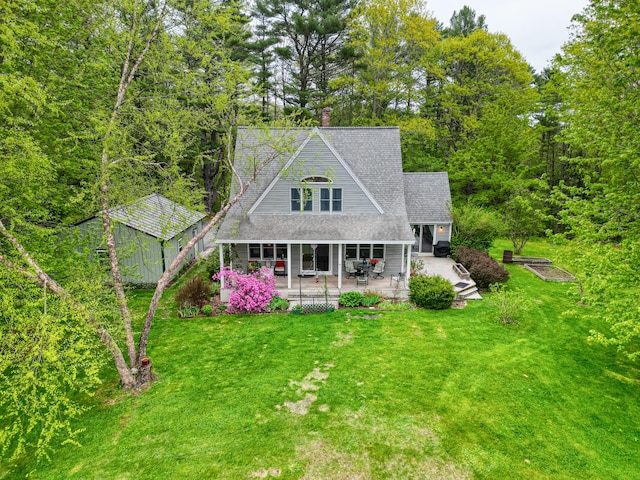 17 Lincoln Ln, Newcastle, ME 04553 - rear view of property with a yard, roof with shingles, a chimney, and a patio area