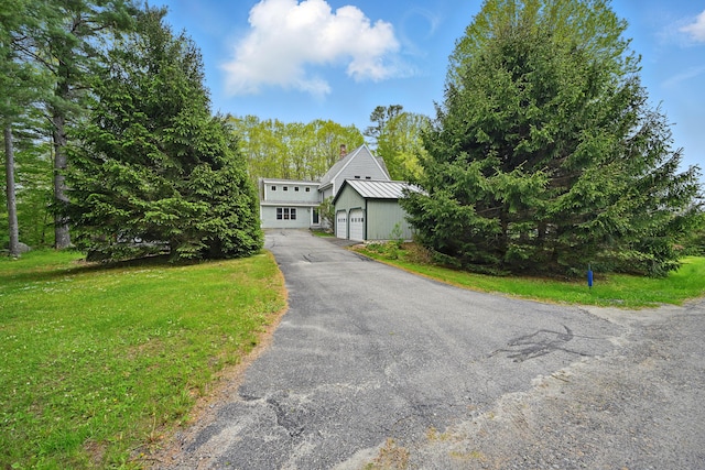 17 Lincoln Ln, Newcastle, ME 04553 - mid-century inspired home featuring a detached garage, a front lawn, and metal roof