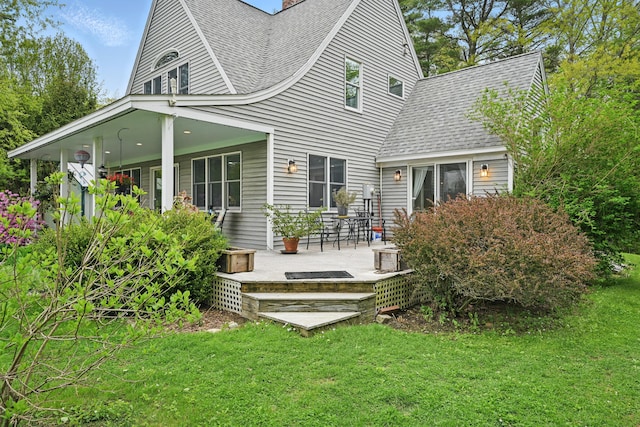 17 Lincoln Ln, Newcastle, ME 04553 - back of house featuring roof with shingles, a lawn, and a patio