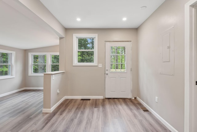 834-836 Sebago Rd, Sebago, ME 04029 - entrance foyer with wood finished floors, baseboards, electric panel, and recessed lighting