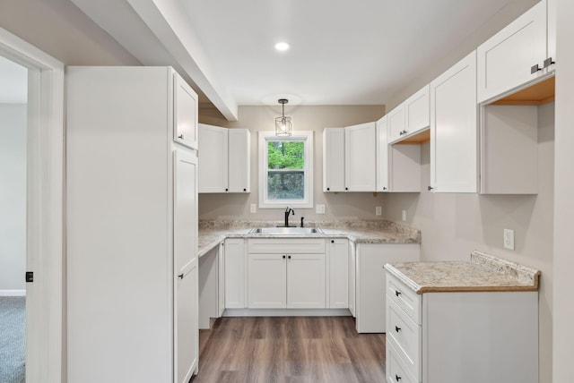 834-836 Sebago Rd, Sebago, ME 04029 - kitchen with a sink, wood finished floors, white cabinets, recessed lighting, and light countertops