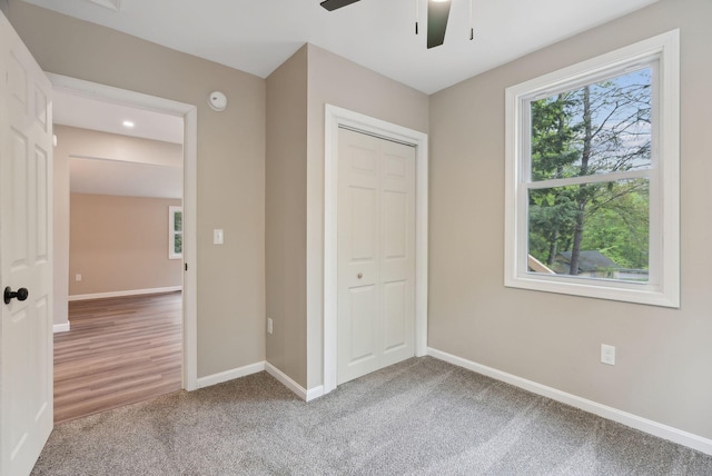 834-836 Sebago Rd, Sebago, ME 04029 - unfurnished bedroom with a closet, baseboards, carpet, and ceiling fan