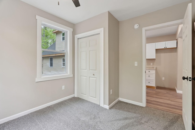 834-836 Sebago Rd, Sebago, ME 04029 - unfurnished bedroom with light colored carpet, baseboards, and a closet