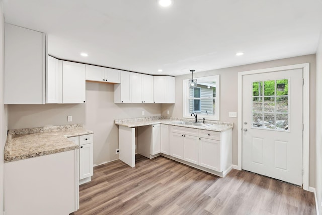 834-836 Sebago Rd, Sebago, ME 04029 - kitchen with a sink, light wood-style floors, white cabinetry, recessed lighting, and hanging light fixtures