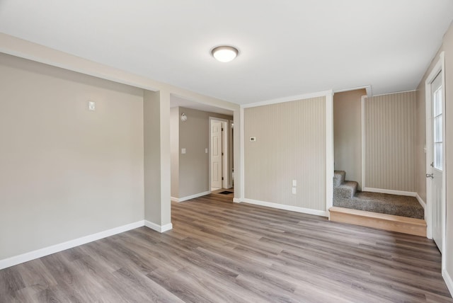 834-836 Sebago Rd, Sebago, ME 04029 - unfurnished room with wood finished floors, stairway, and baseboards