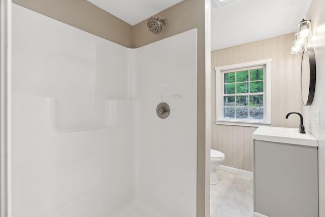 834-836 Sebago Rd, Sebago, ME 04029 - bathroom featuring a shower, toilet, vanity, baseboards, and wood walls