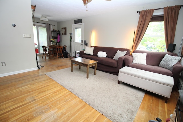 24 Mitchell St, Lewiston, ME 04240 - living room with wood finished floors, baseboards, and a ceiling fan