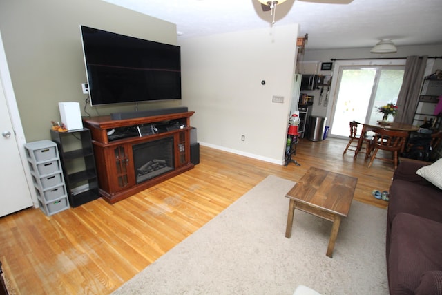 24 Mitchell St, Lewiston, ME 04240 - living area with wood finished floors, baseboards, and ceiling fan
