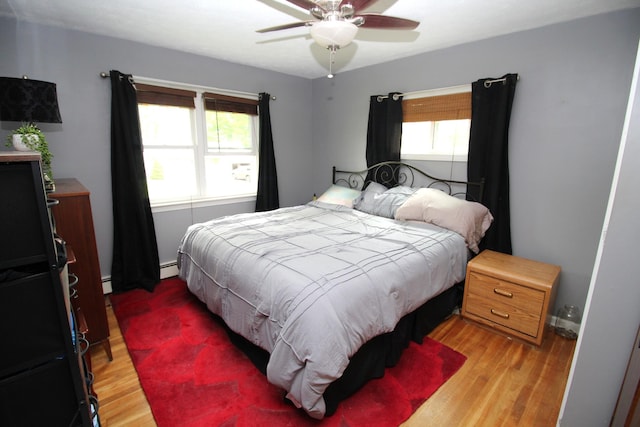 24 Mitchell St, Lewiston, ME 04240 - bedroom with light wood finished floors, baseboard heating, and ceiling fan