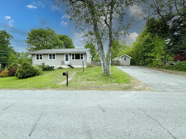 24 Mitchell St, Lewiston, ME 04240 - view of front facade with driveway, a front yard, metal roof, and a standing seam roof
