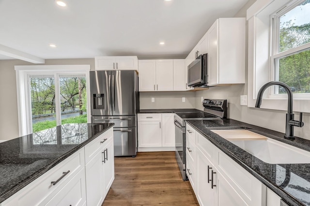 61 Main Rd, Eddington, ME 04428 - kitchen with stainless steel appliances, a sink, healthy amount of natural light, recessed lighting, and white cabinetry
