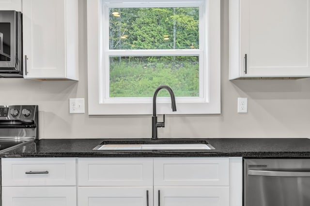 61 Main Rd, Eddington, ME 04428 - kitchen featuring appliances with stainless steel finishes, a sink, and white cabinets