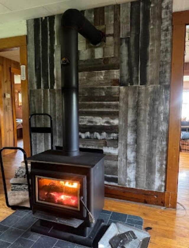 634 N Rd, Mount Chase, ME 04765 - detailed view of a wood stove, wood walls, and wood finished floors