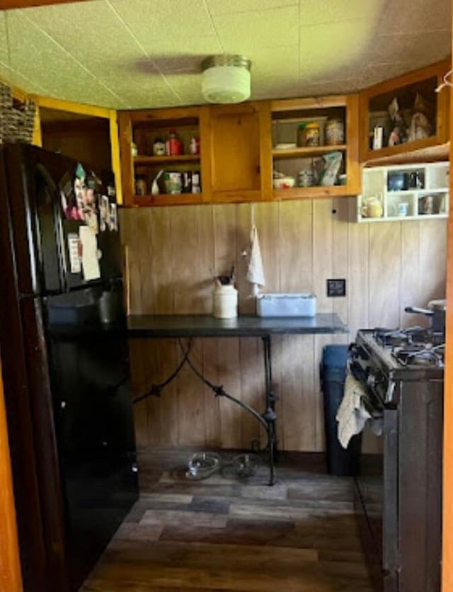 634 N Rd, Mount Chase, ME 04765 - kitchen featuring black appliances, wood finished floors, wooden walls, open shelves, and built in shelves