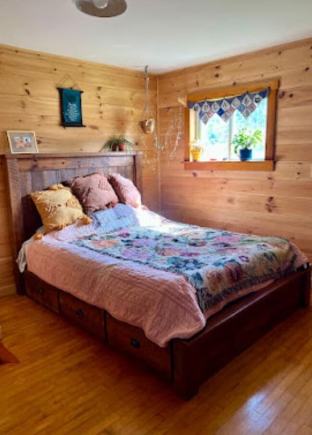 634 N Rd, Mount Chase, ME 04765 - bedroom with wood walls and wood-type flooring