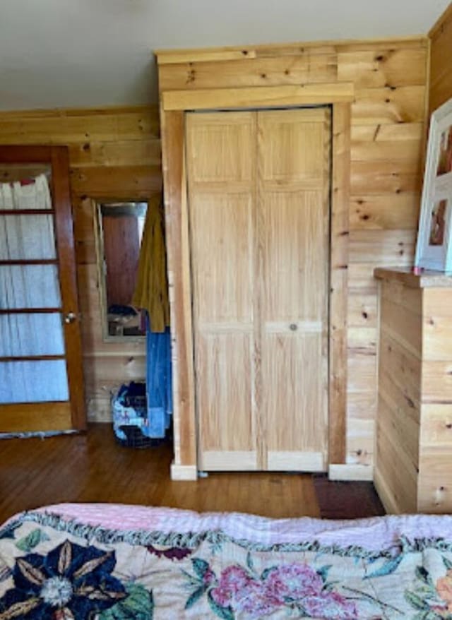 634 N Rd, Mount Chase, ME 04765 - bedroom featuring wood walls, wood finished floors, and a closet