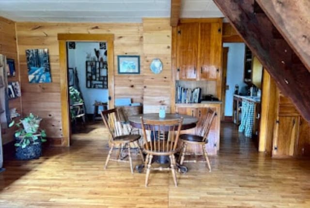 634 N Rd, Mount Chase, ME 04765 - dining room featuring light wood-style floors and wood walls