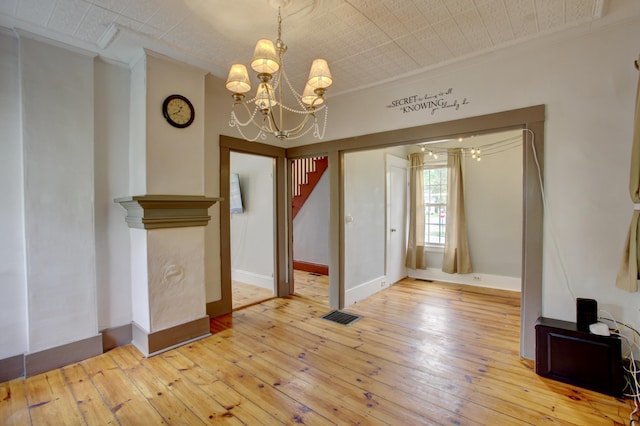 6 Sokokis Trl N, Cornish, ME 04020 - unfurnished dining area with a chandelier, crown molding, wood-type flooring, and baseboards