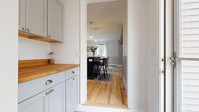 53 Gray Rd, Gorham, ME 04038 - kitchen featuring light wood finished floors, wood counters, decorative light fixtures, and a baseboard radiator