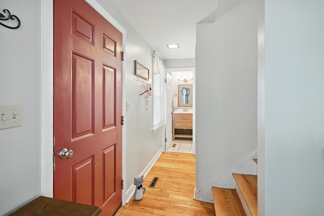 29 Emanual Dr, Brunswick, ME 04011 - corridor featuring light wood finished floors, stairs, and baseboards