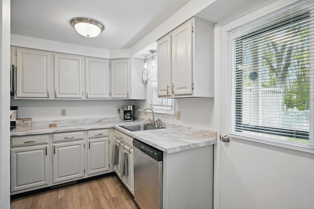 29 Emanual Dr, Brunswick, ME 04011 - kitchen featuring stainless steel dishwasher, a sink, wood finished floors, and white cabinetry