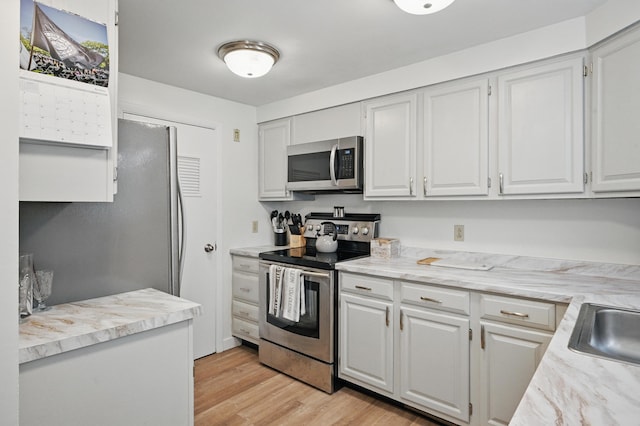 29 Emanual Dr, Brunswick, ME 04011 - kitchen featuring stainless steel appliances, light wood-type flooring, and white cabinets