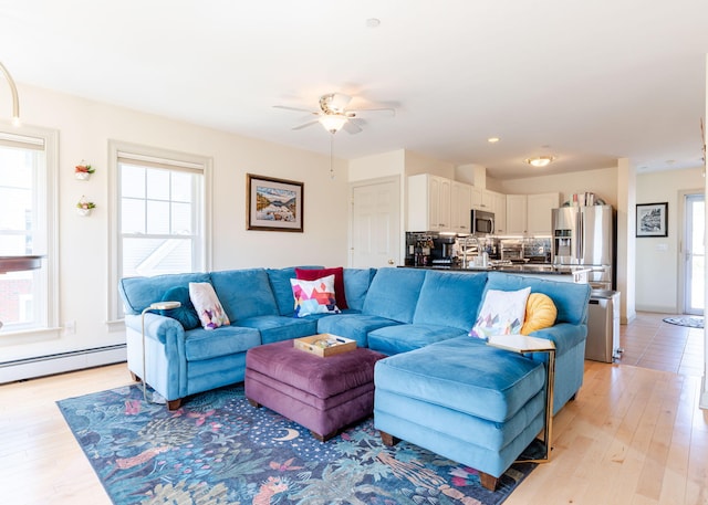 22 Cormorant Pl Unit 22, South Portland, ME 04106 - living room featuring ceiling fan, light wood-type flooring, and a baseboard heating unit