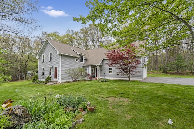 241 Old Stage Rd, Arrowsic, ME 04530 - view of front of house featuring a shingled roof, a front yard, entry steps, and asphalt driveway