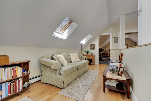 241 Old Stage Rd, Arrowsic, ME 04530 - living room featuring a skylight, vaulted ceiling, a baseboard radiator, and wood finished floors