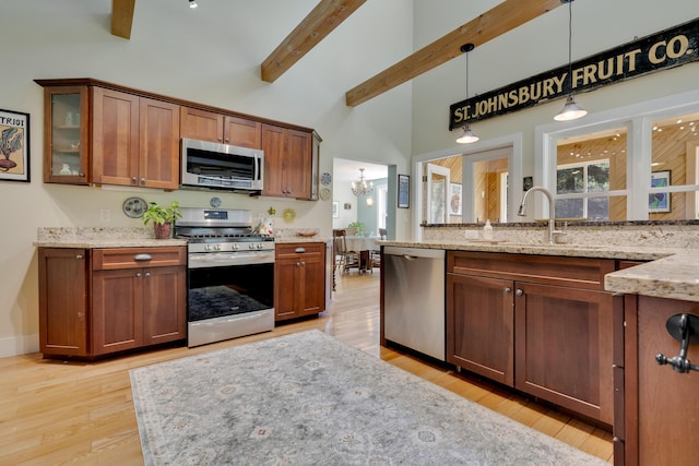 241 Old Stage Rd, Arrowsic, ME 04530 - kitchen featuring appliances with stainless steel finishes, a towering ceiling, beam ceiling, a sink, and light stone counters
