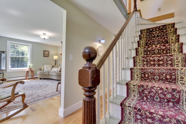 241 Old Stage Rd, Arrowsic, ME 04530 - stairs with a baseboard heating unit, wood finished floors, and baseboards