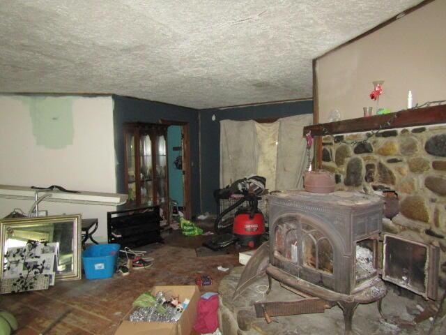 33 Log N Rock Rd, Eliot, ME 03442 - living area with a wood stove and a textured ceiling