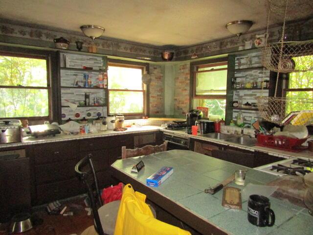 33 Log N Rock Rd, Eliot, ME 03442 - kitchen featuring tile counters, healthy amount of natural light, and white gas stovetop