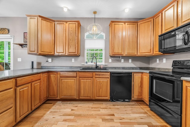 700 Pond Rd, Saint Albans, ME 04971 - kitchen with black appliances, a sink, light wood-style floors, pendant lighting, and dark countertops