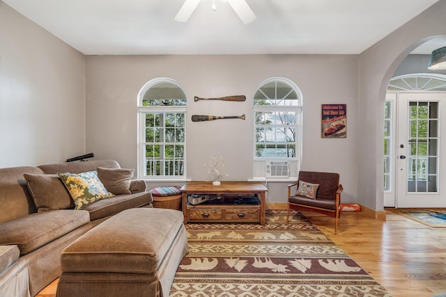 700 Pond Rd, Saint Albans, ME 04971 - living room featuring wood finished floors, arched walkways, cooling unit, and a ceiling fan